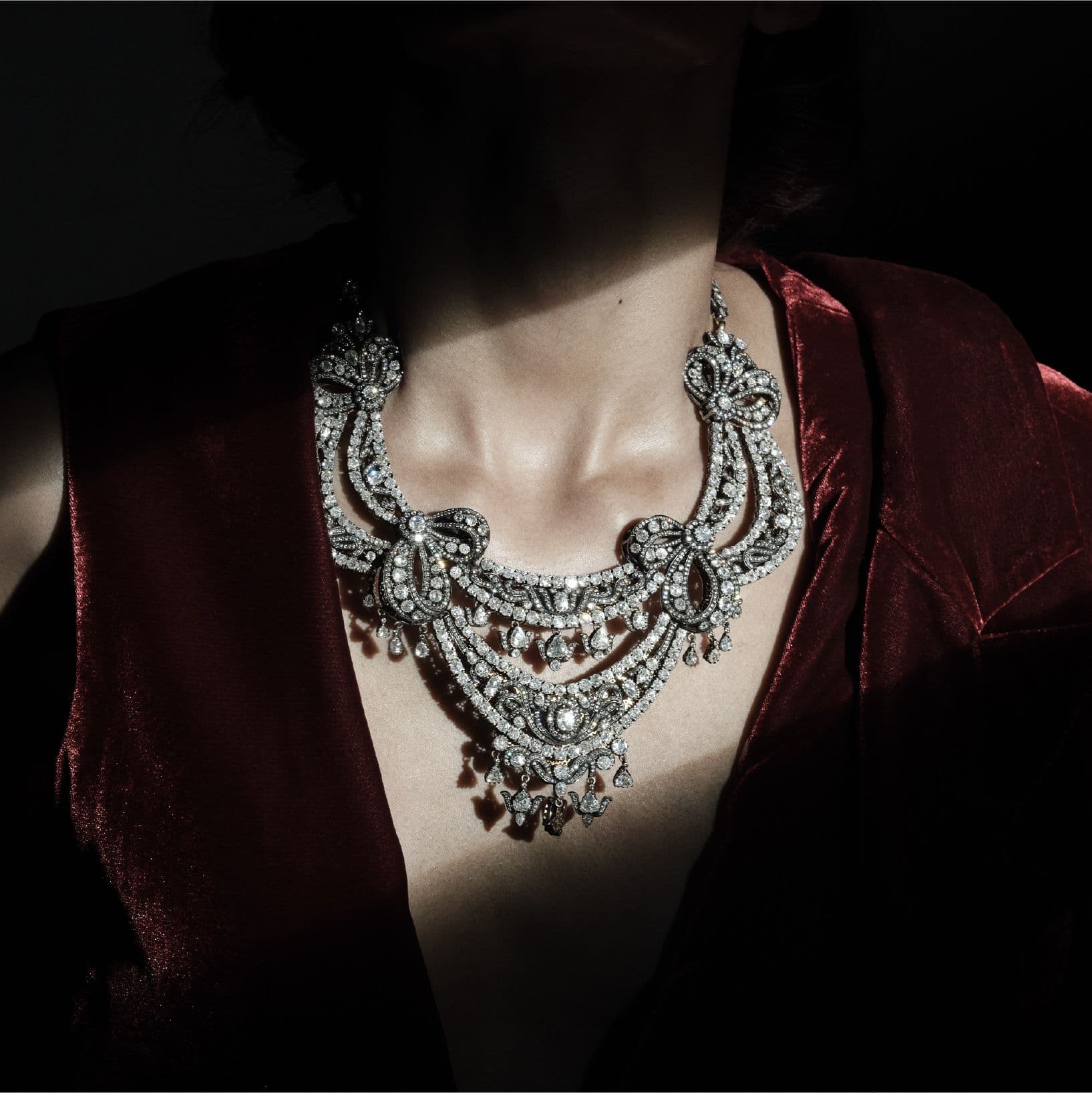 Diamond necklace worn with a deep red robe