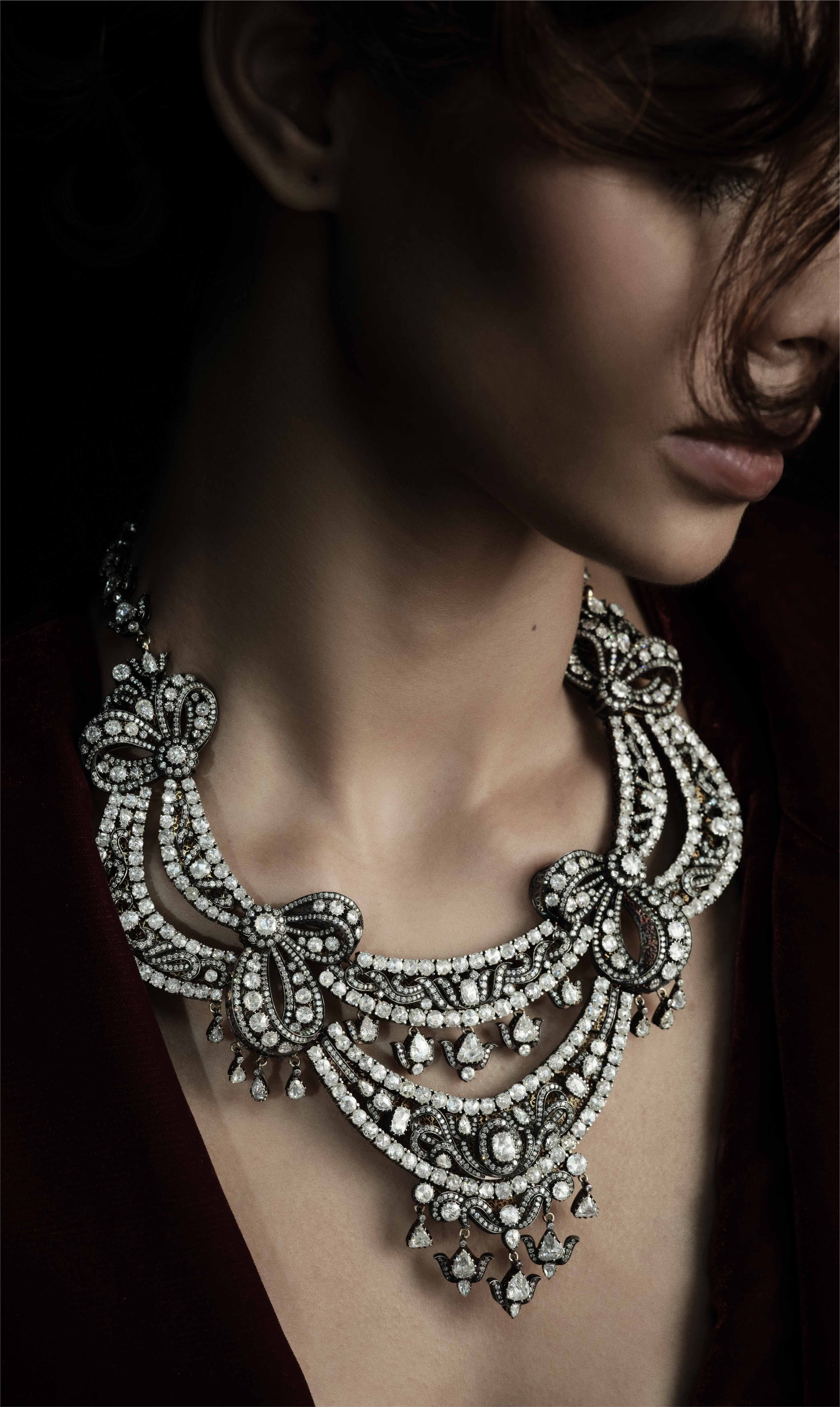 Diamond bib necklace worn close to the neck