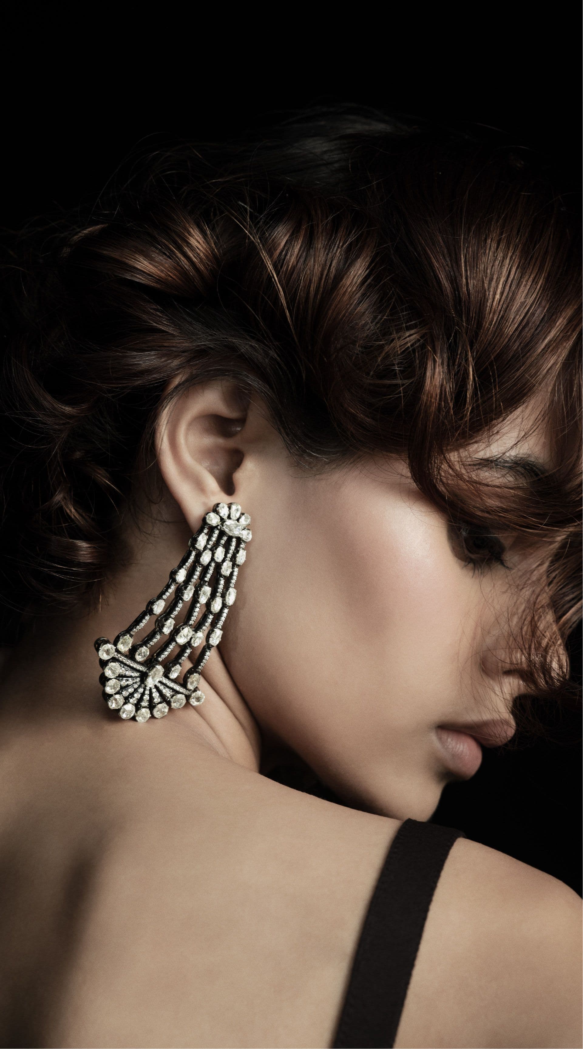 Diamond earring worn in profile