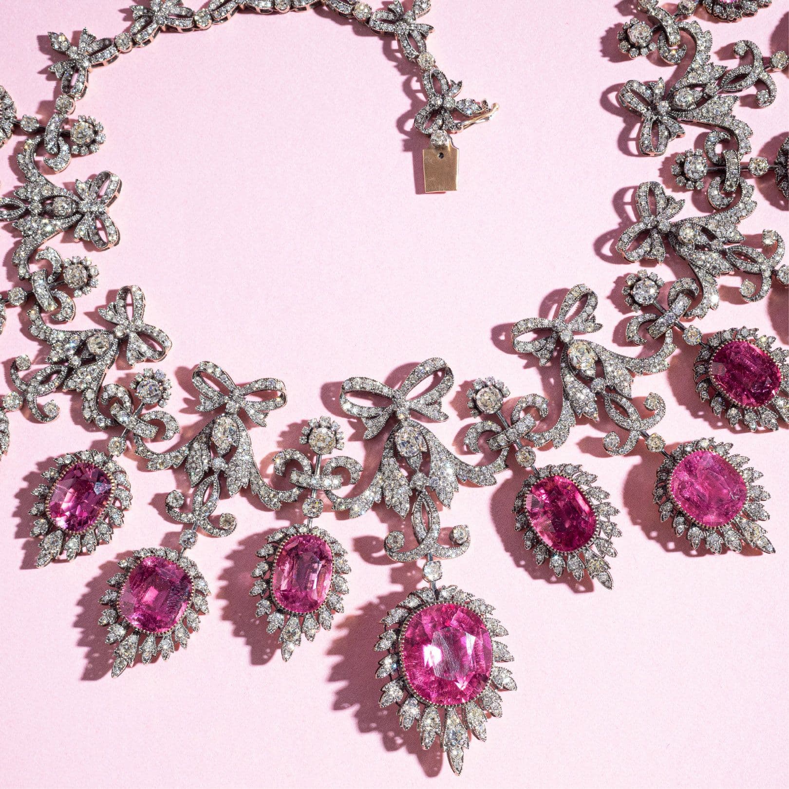 Pink stone bow necklace on pink