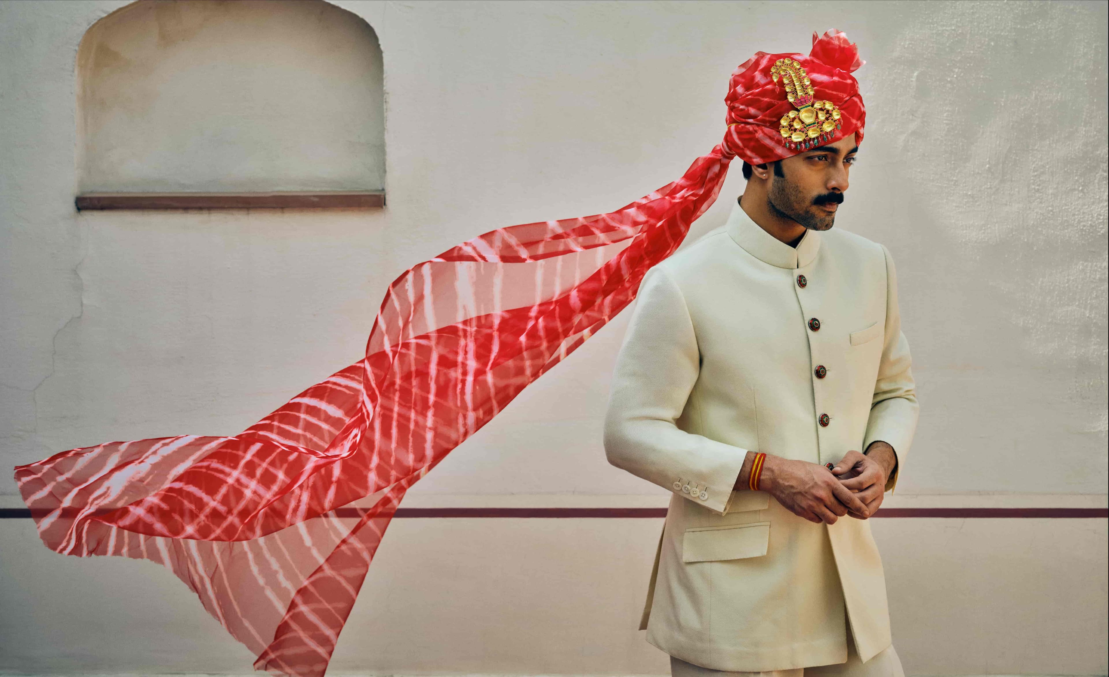 Mhaaro — man in white kurta with pink scarf flying