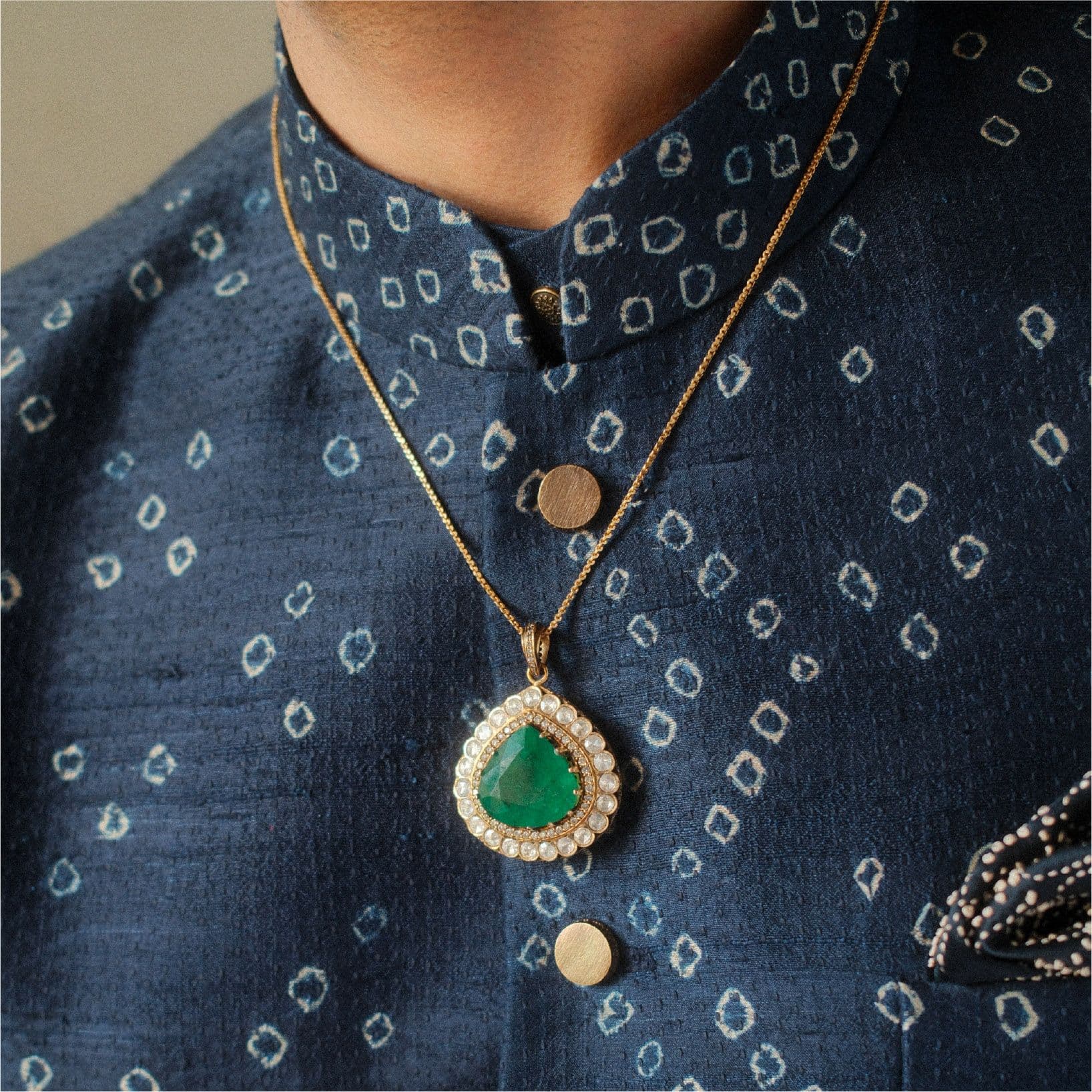 Emerald pendant on blue bandhani