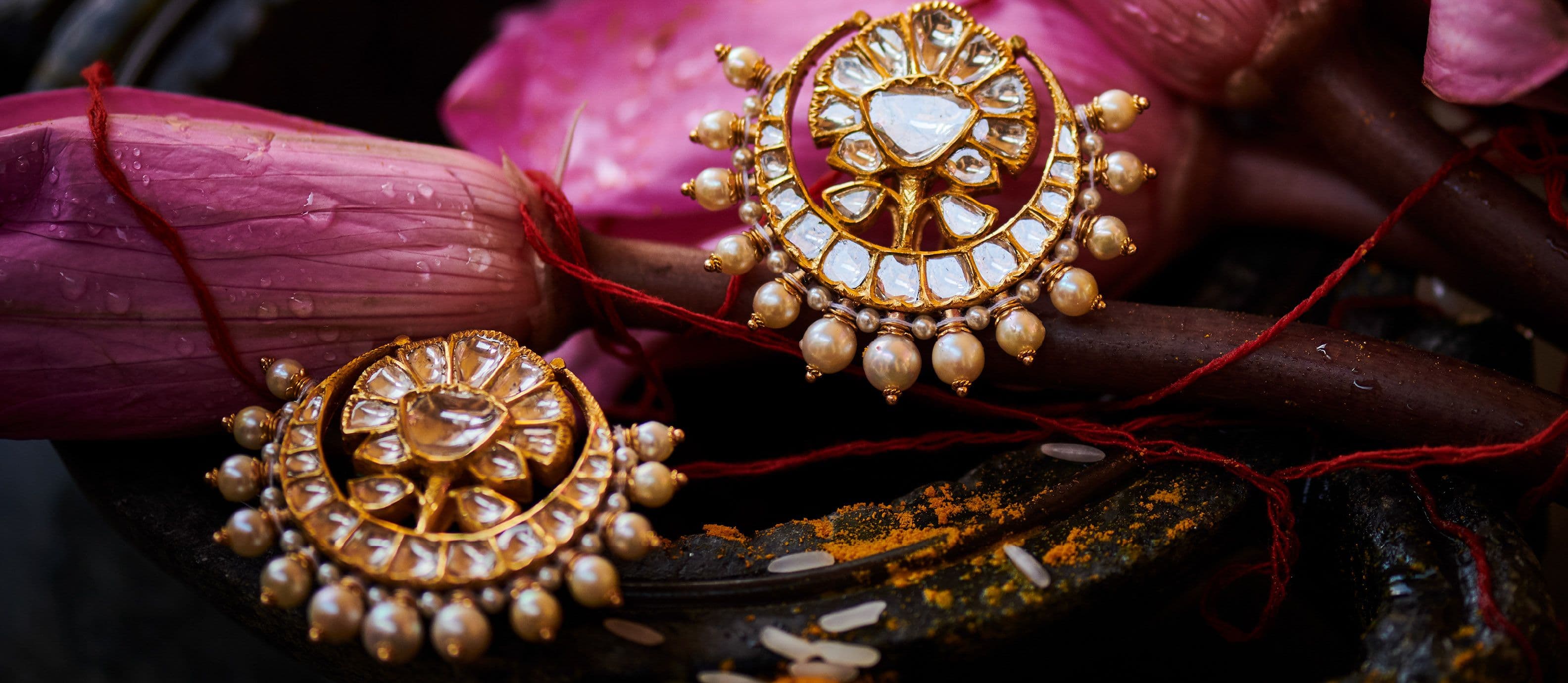 Pearl-ringed polki studs resting on lotus buds