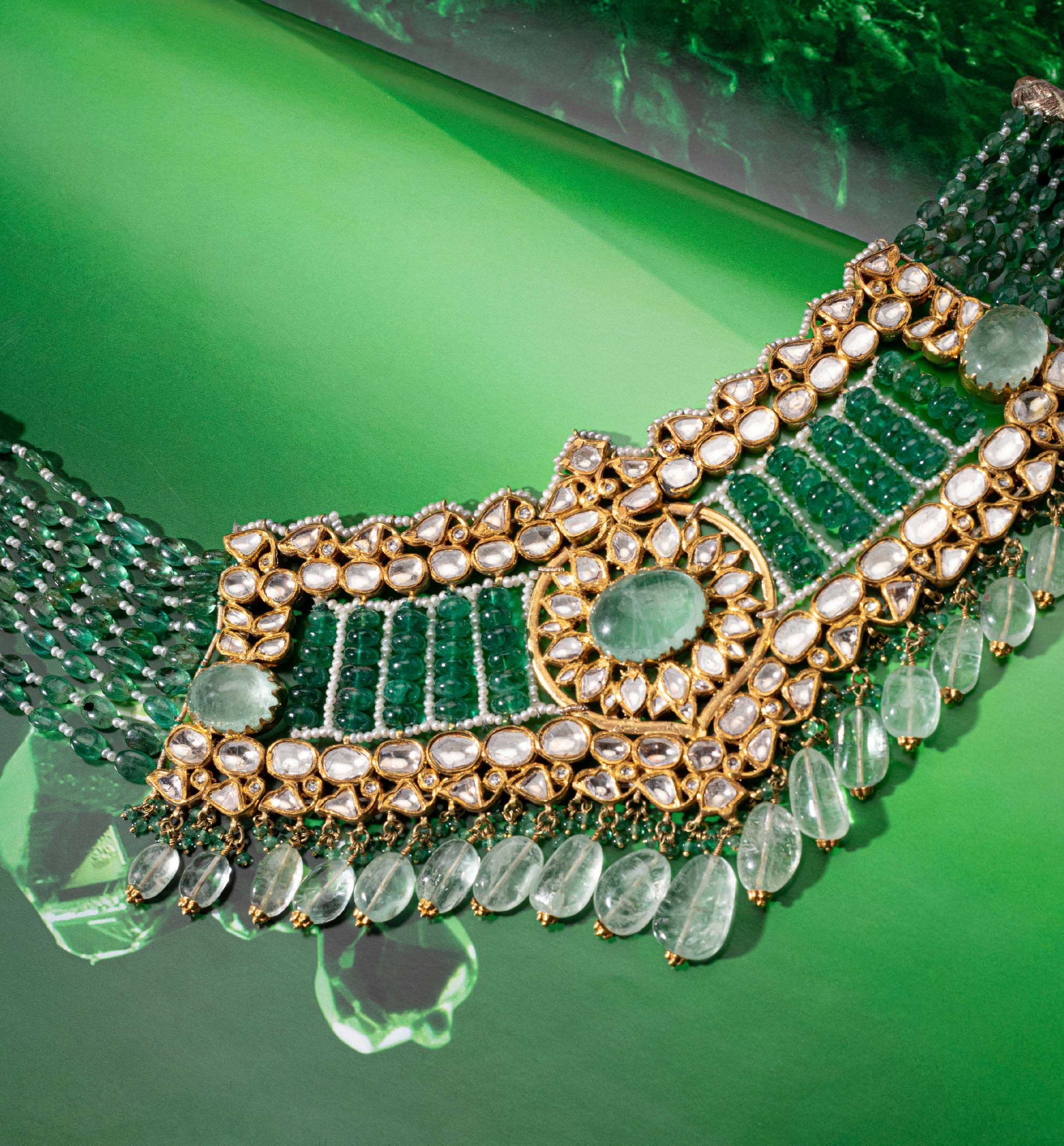 Emerald and polki choker photographed on green glass